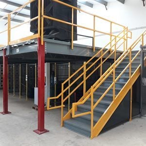Free-standing warehouse mezzanine platform with stairs and safety railings